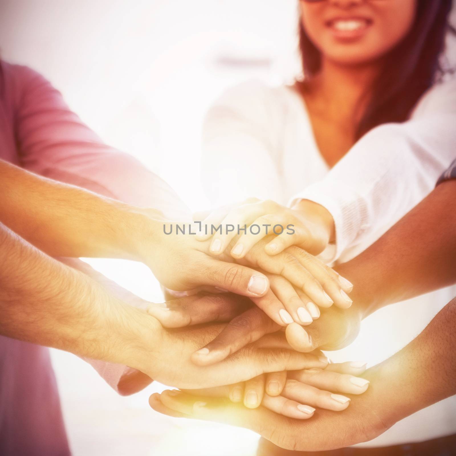 Businesswoman stacking hands with team by Wavebreakmedia