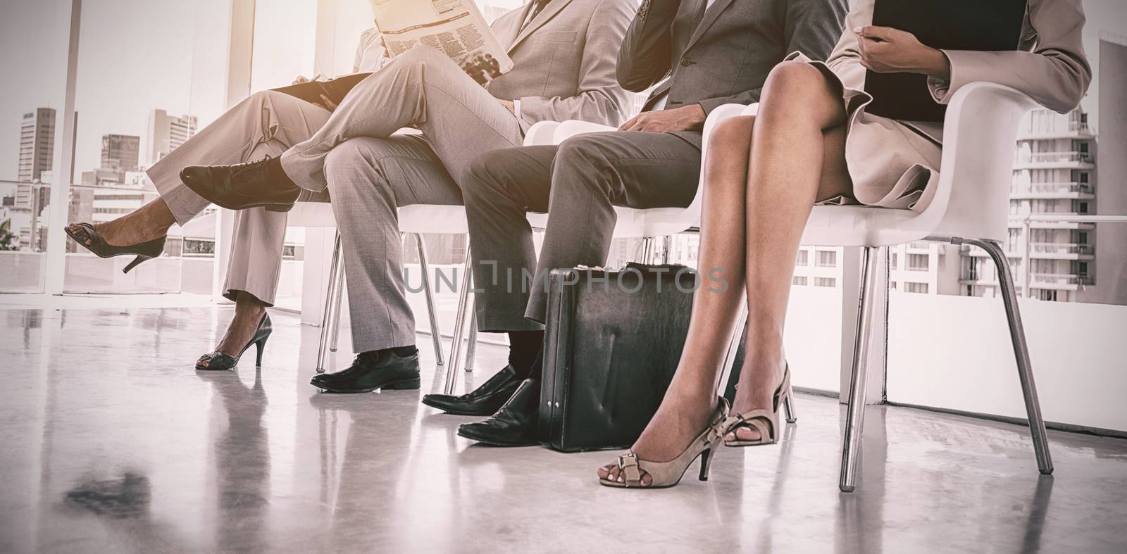 Business people working while waiting by Wavebreakmedia