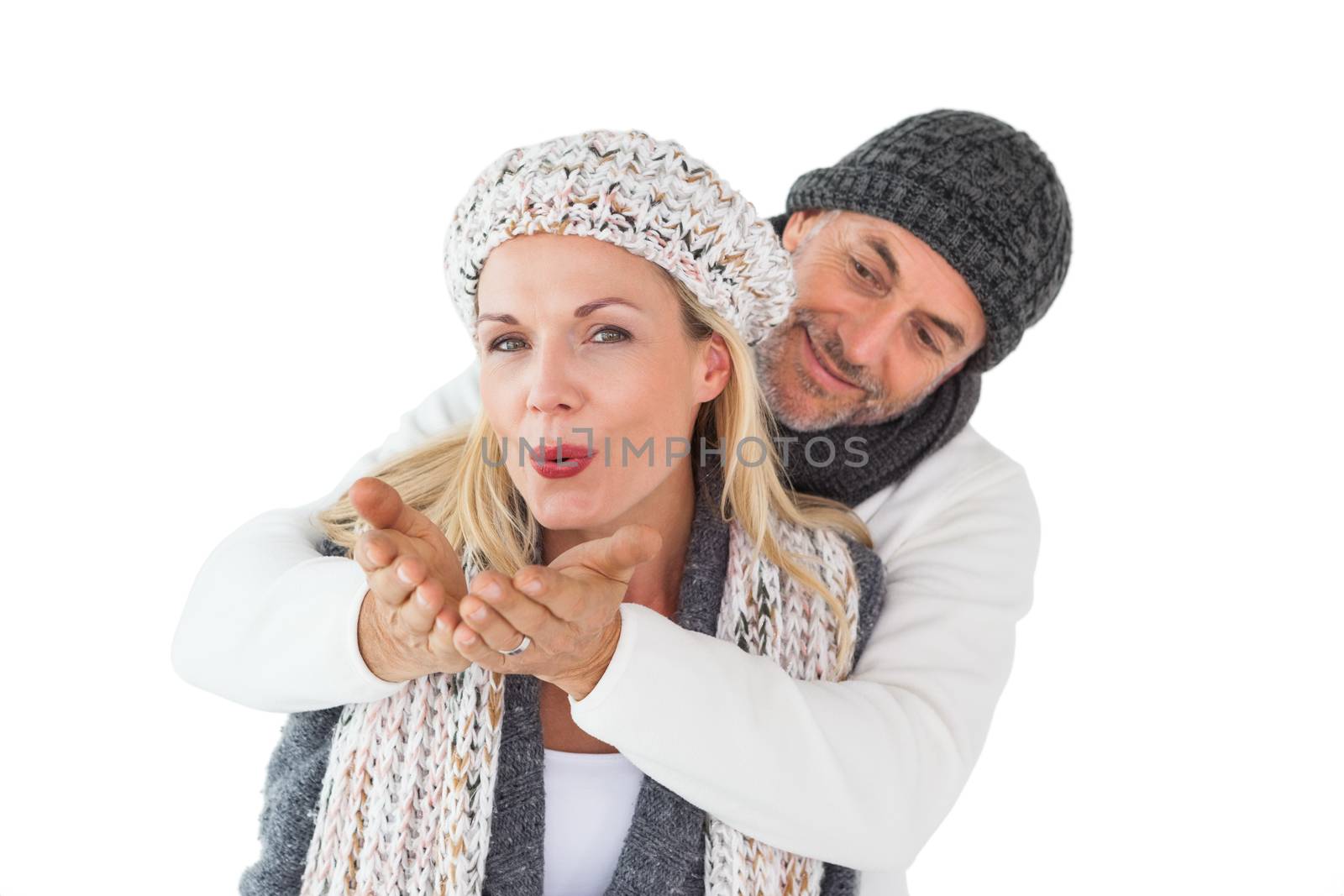 Smiling couple in winter fashion posing by Wavebreakmedia