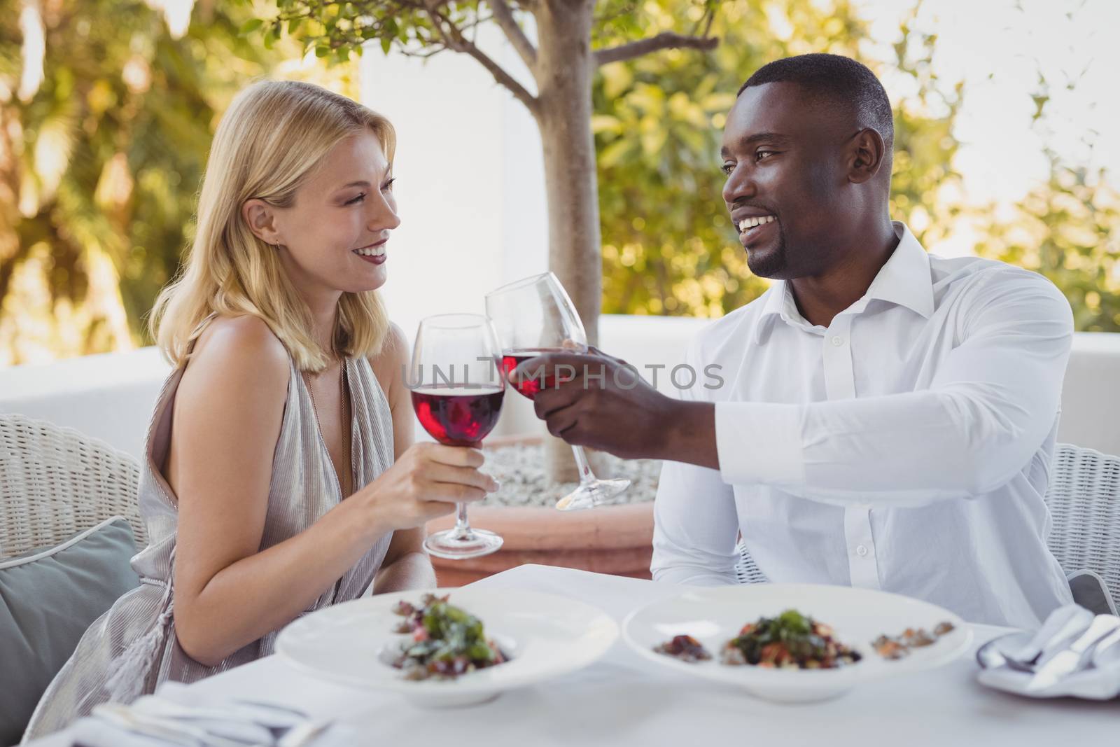 Romantic couple toasting their wine glasses in restaurant