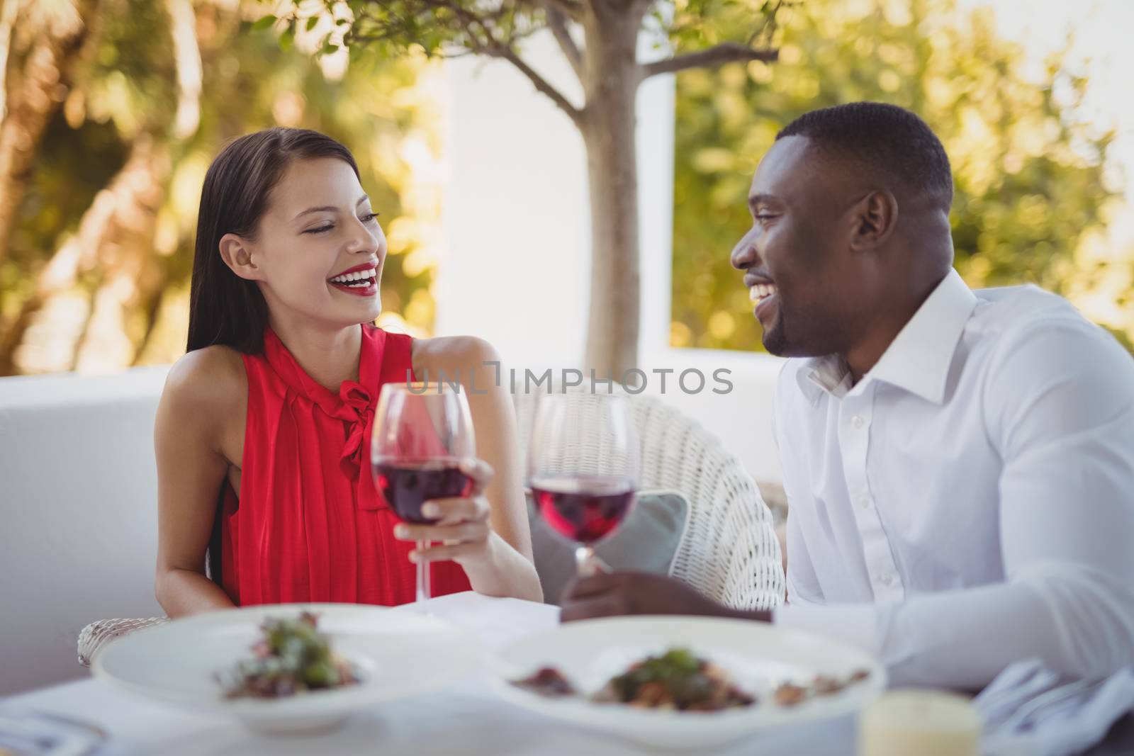 Romantic couple toasting their wine glasses in restaurant