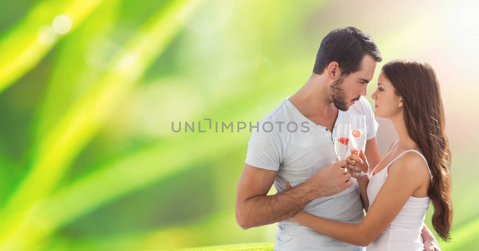 Digital composite of Loving couple holding champagne flutes outdoors