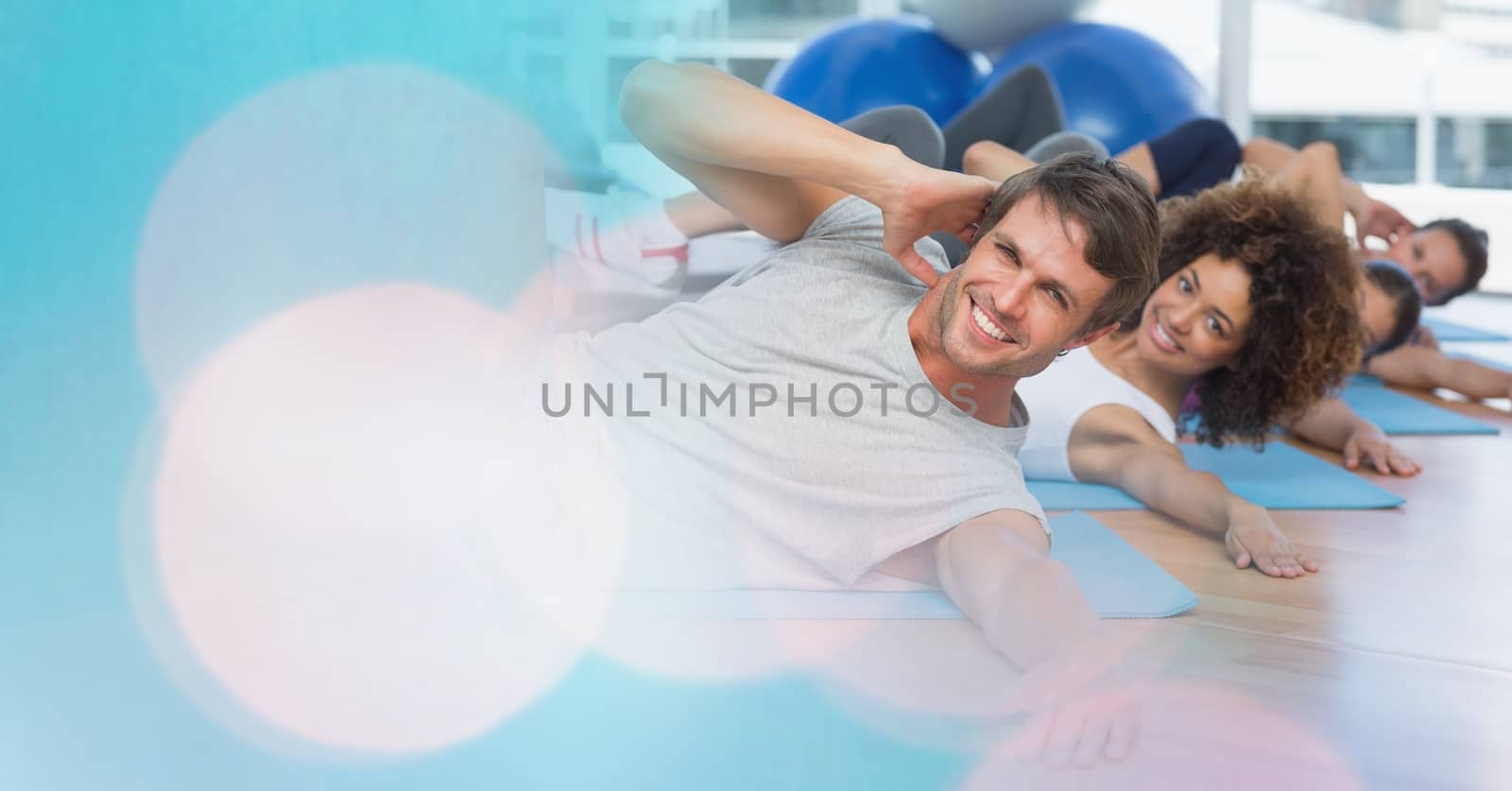 Digital composite of People on yoga matts and blue bokeh transition
