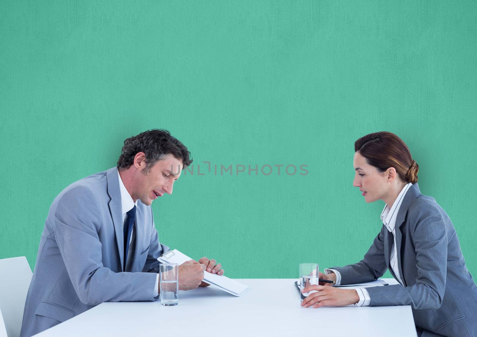 Digital composite of Business people discussing over documents