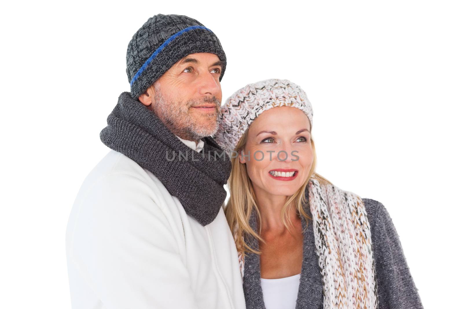 Happy couple in winter fashion embracing by Wavebreakmedia