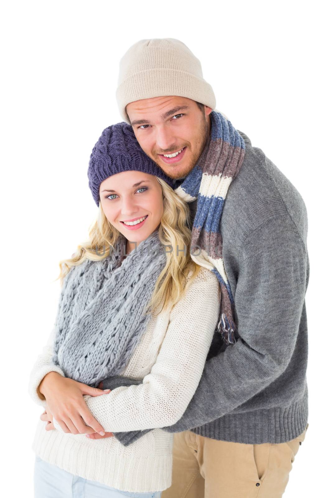 Attractive couple in winter fashion hugging by Wavebreakmedia