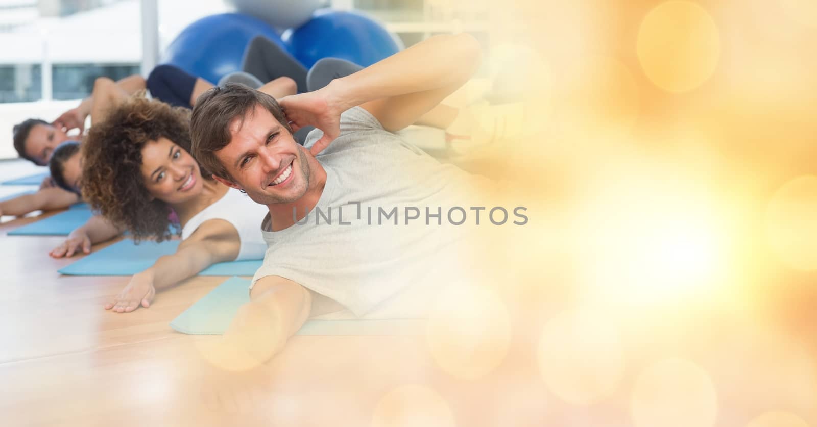 Digital composite of People on yoga matts and yellow bokeh transition