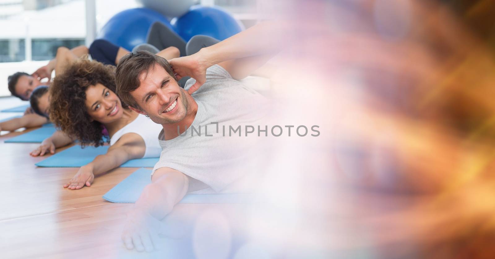 Digital composite of People on yoga matts and pink orange bokeh transition