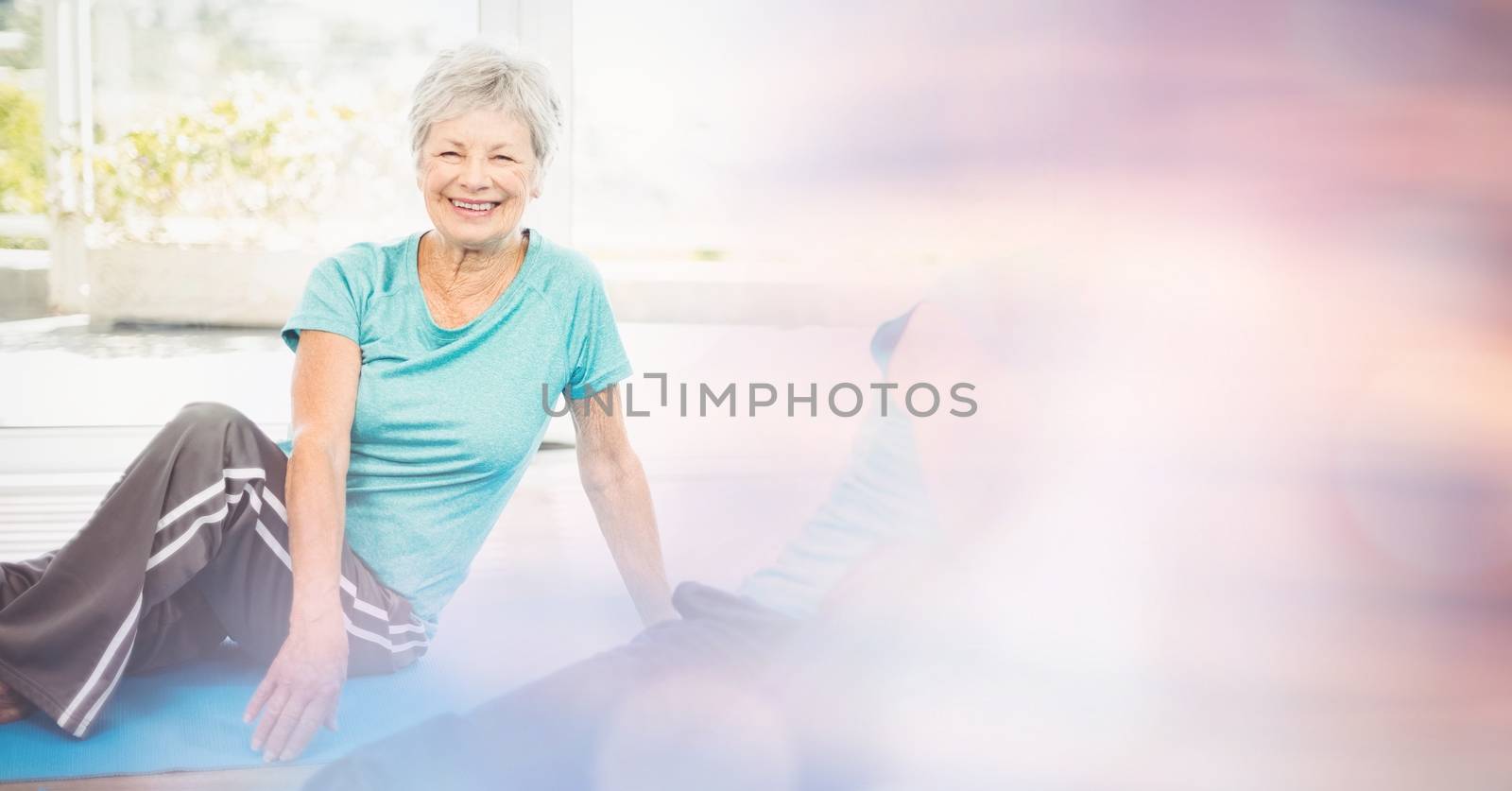 Digital composite of Fit senior woman exercising in yoga class