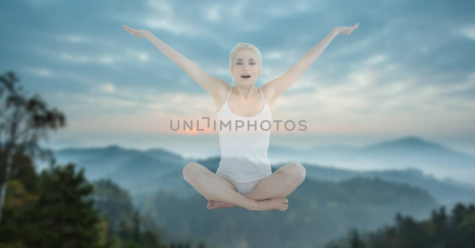 Digital composite of Double exposure of woman performing yoga in midair against mountains