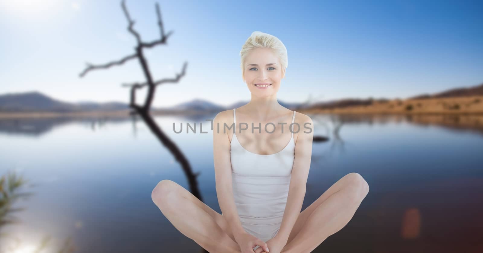 Digital composite of Double exposure of woman performing yoga at lake shore