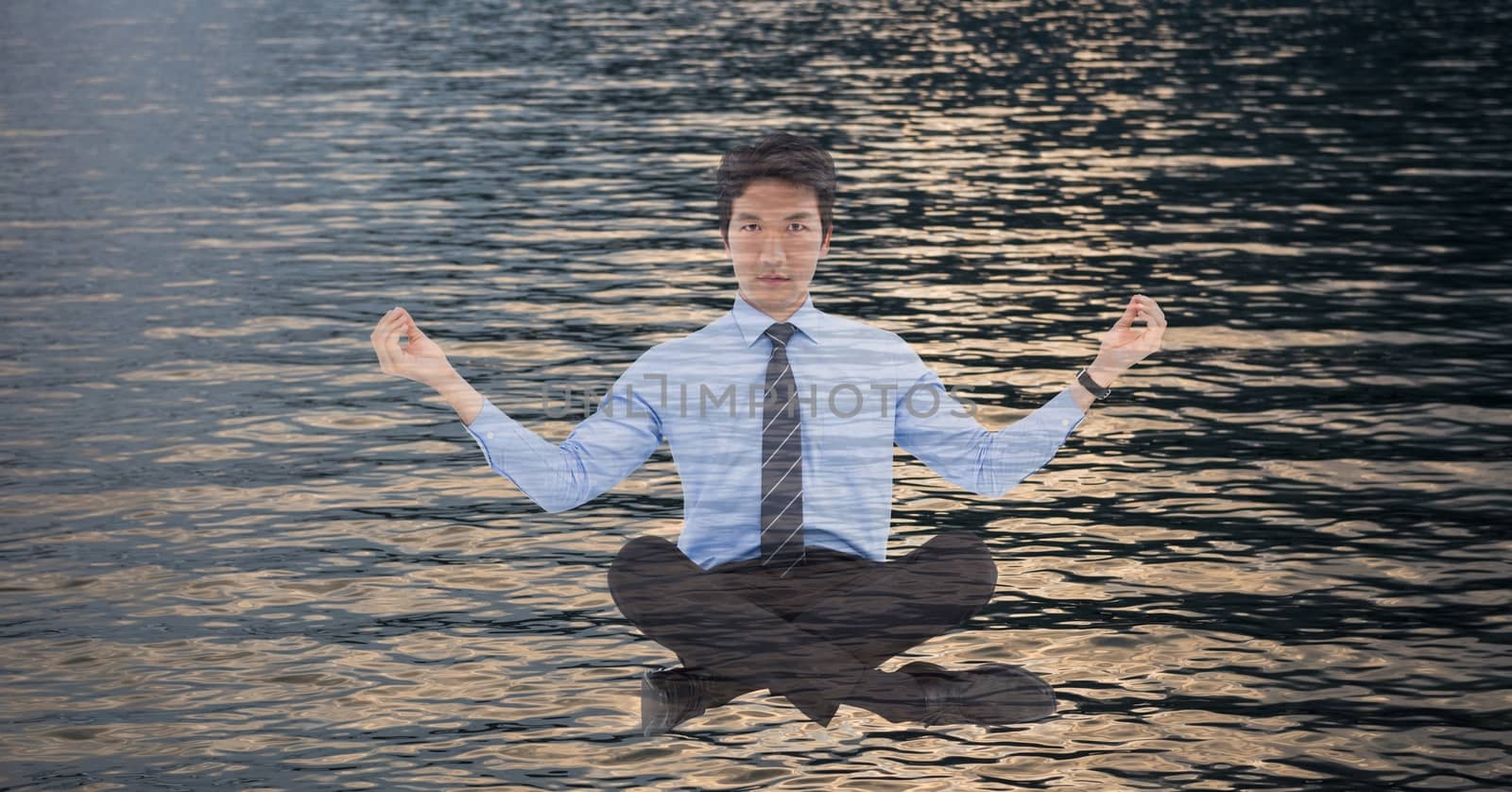 Digital composite of Double exposure of businessman doing yoga over sea