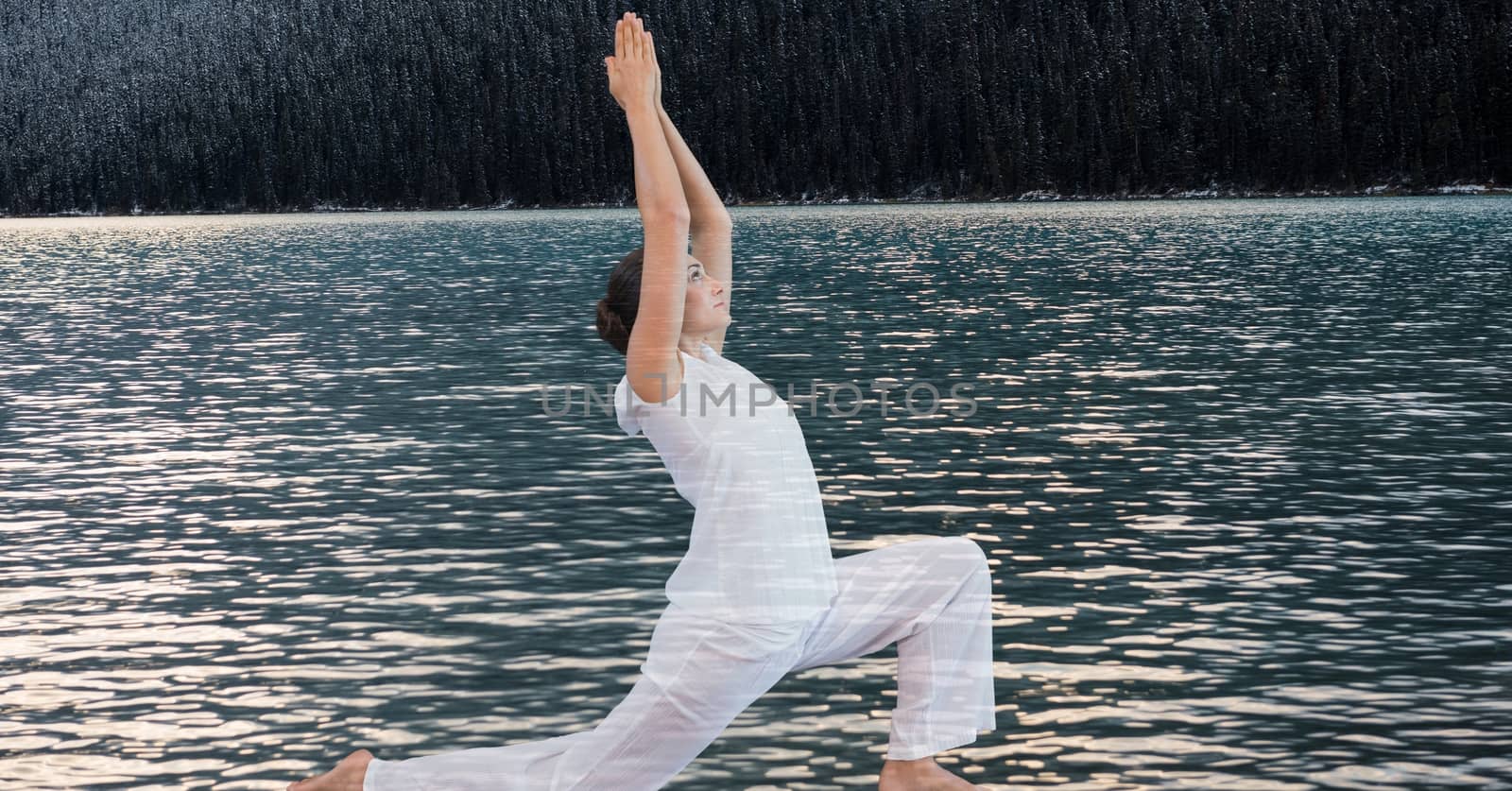 Digital composite of Double exposure of woman performing yoga by lake
