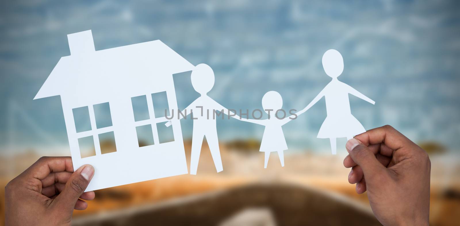 Composite image of hands holding a family with her house in paper by Wavebreakmedia