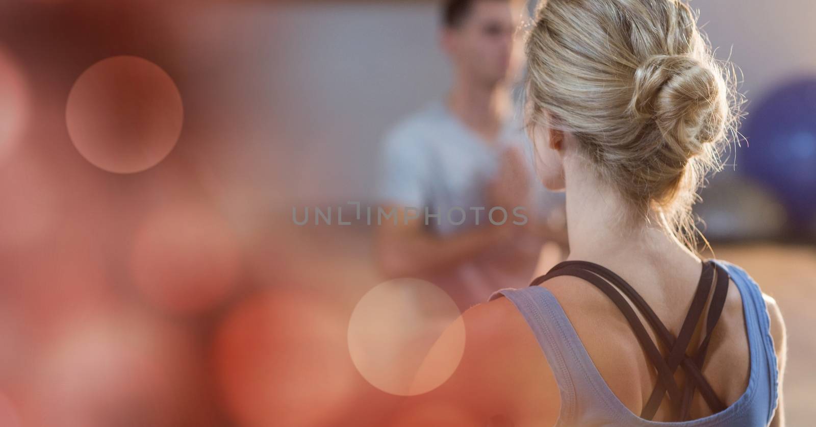 Digital composite of Rear view of woman doing yoga in gym