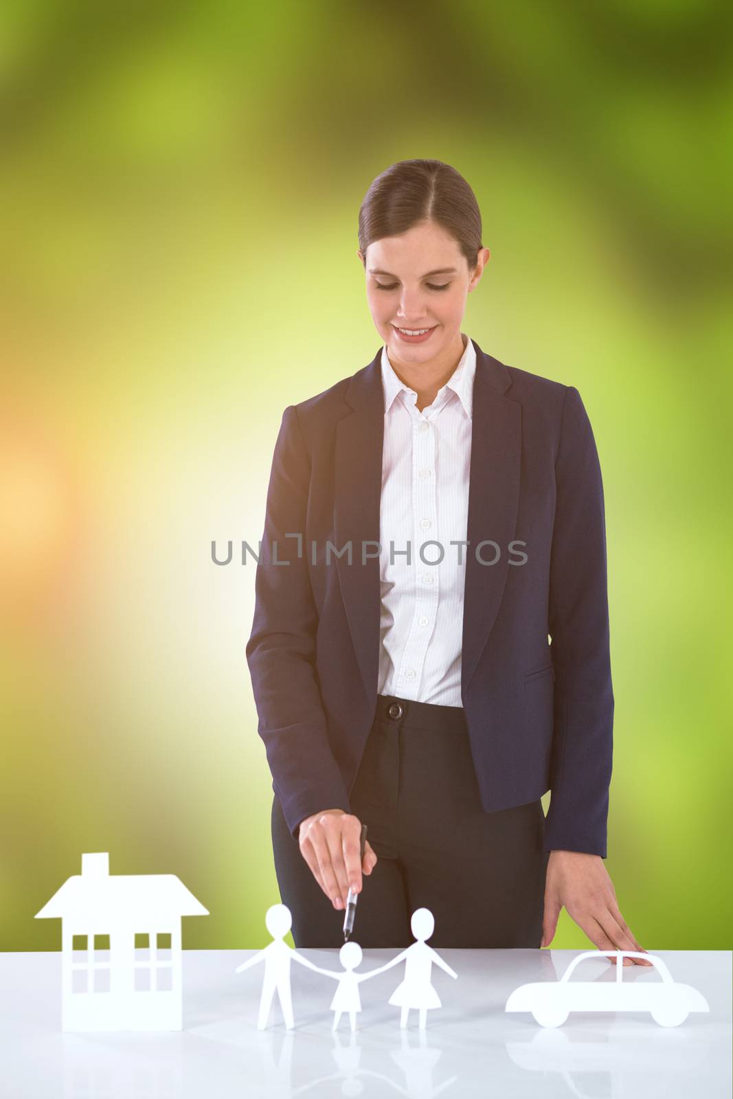 Composite image of woman drawing a car, a family and a house by Wavebreakmedia