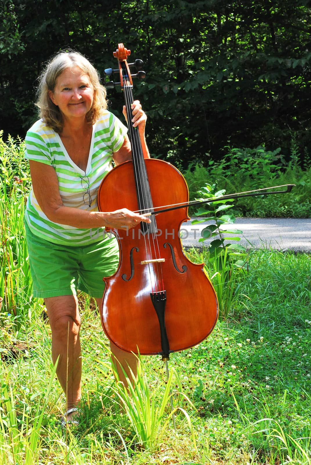 Female cellist outside. by oscarcwilliams