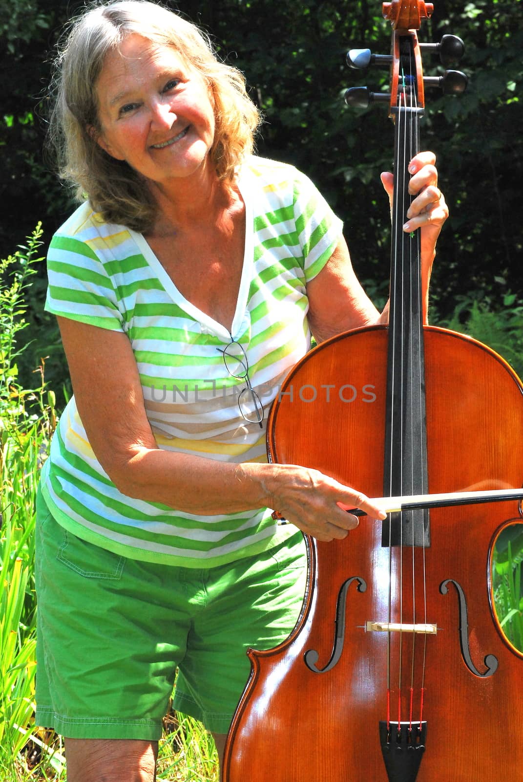 Female cellist outside. by oscarcwilliams