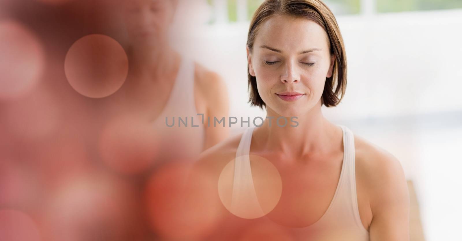 Digital composite of Women meditating in yoga studio