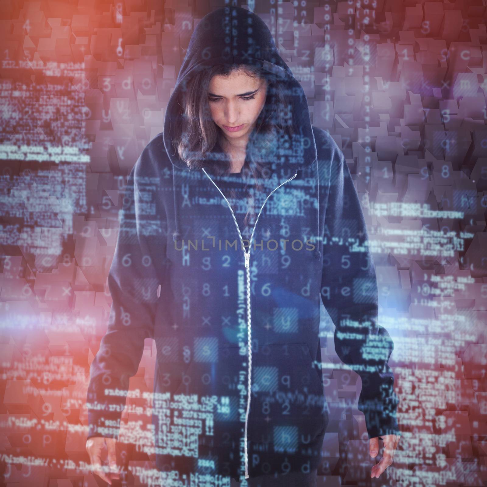 Young female hacker in black hoodie standing  against graphic image of blocks