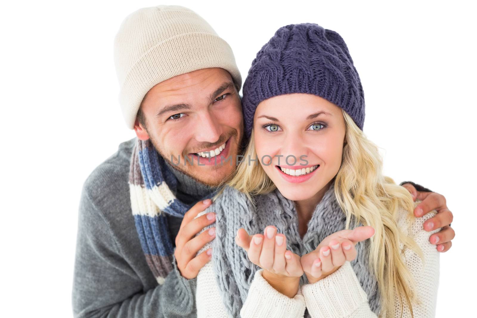 Attractive couple in winter fashion smiling at camera by Wavebreakmedia