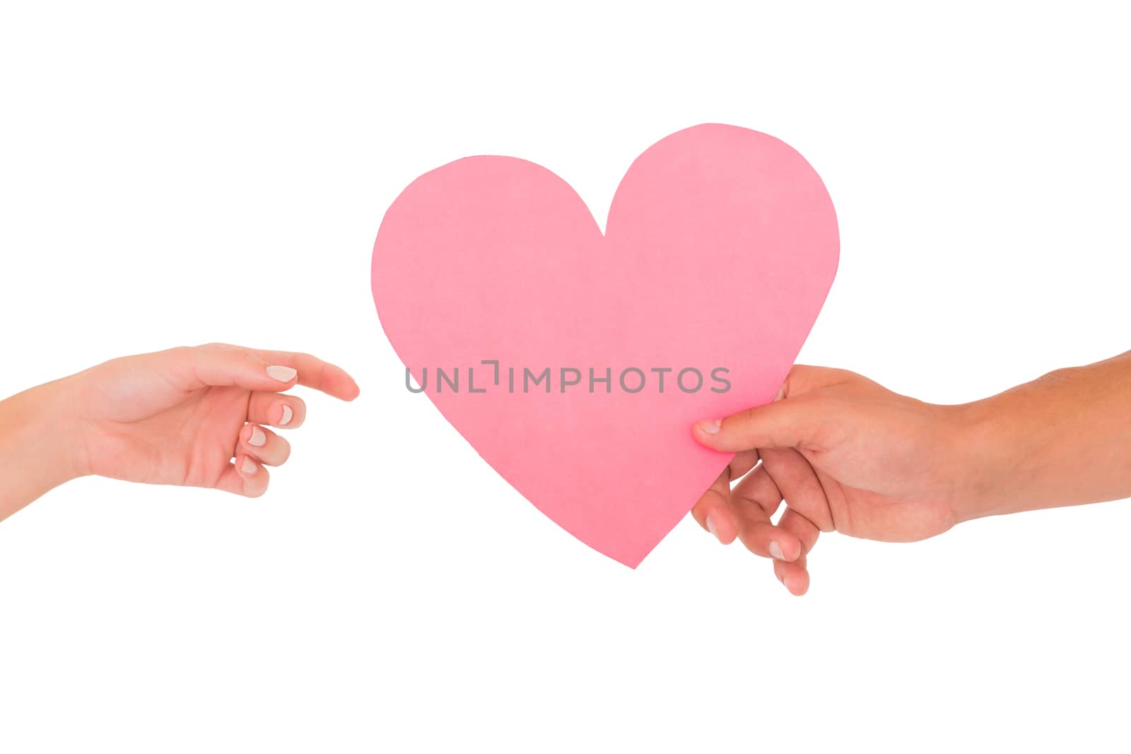 Couple passing a paper heart by Wavebreakmedia