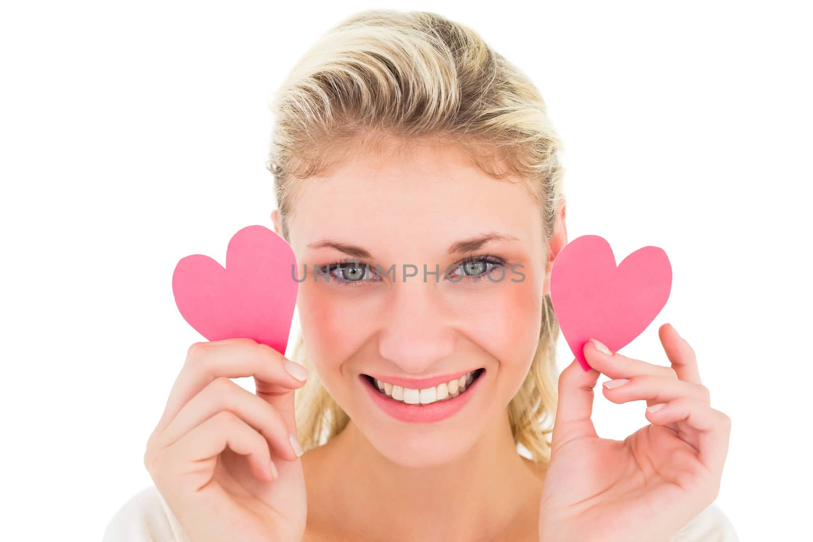 Attractive young blonde holding little hearts on white background