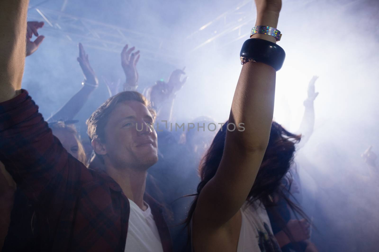 Group of people dancing at a concert by Wavebreakmedia