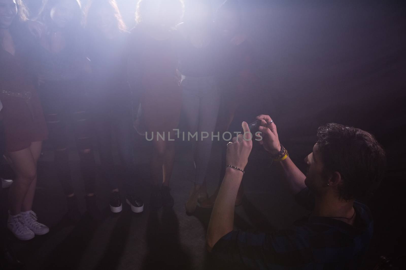 Group of people dancing at a concert in nightclub