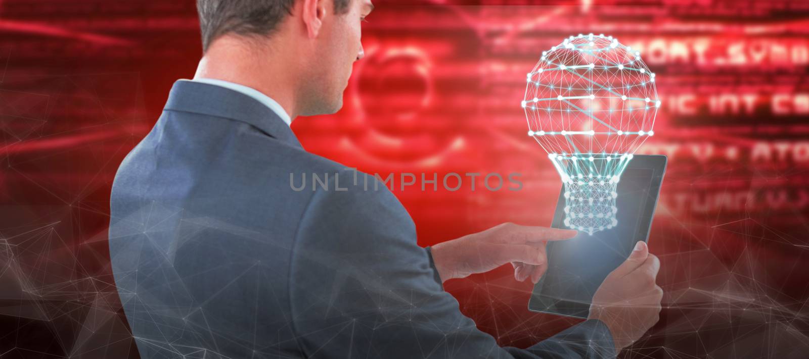 Businessman using tablet against abstract pink text