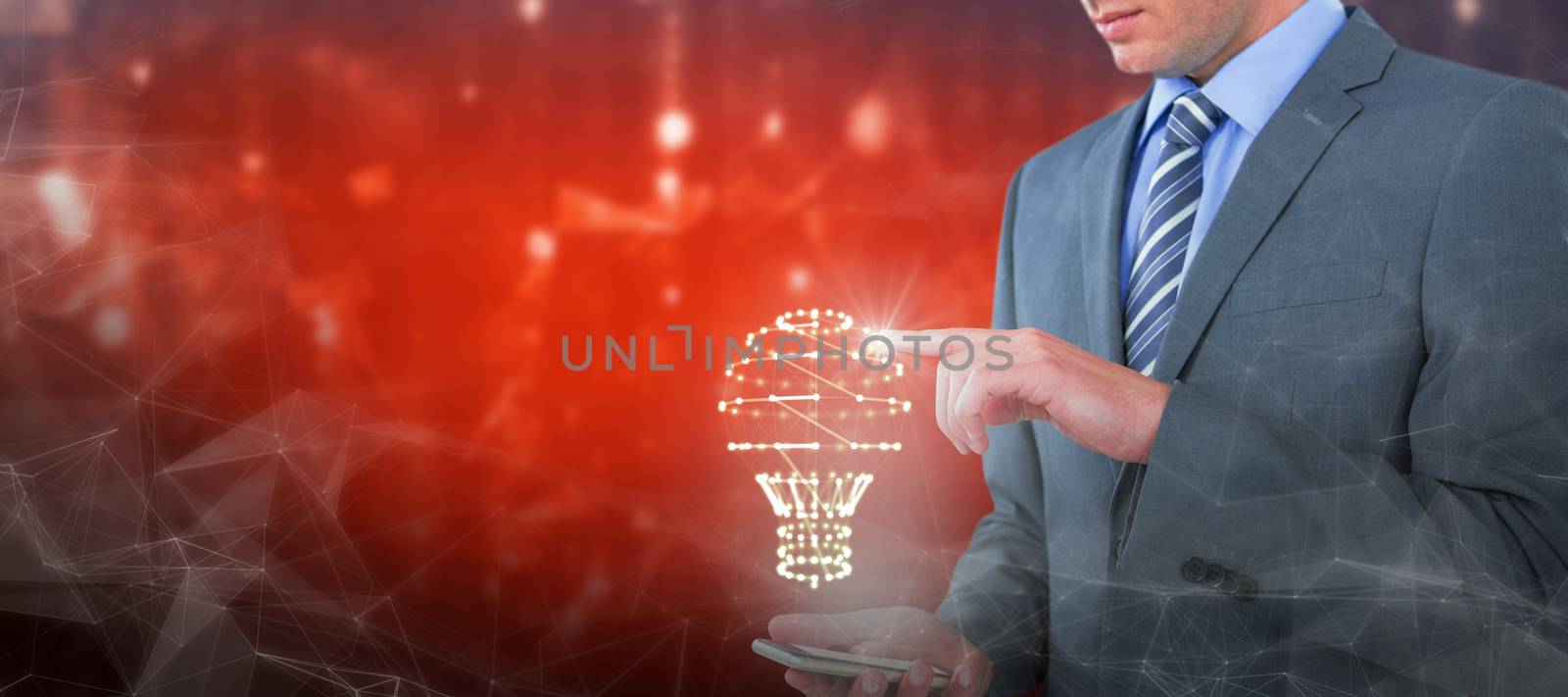 Businessman using mobile phone against abstract background