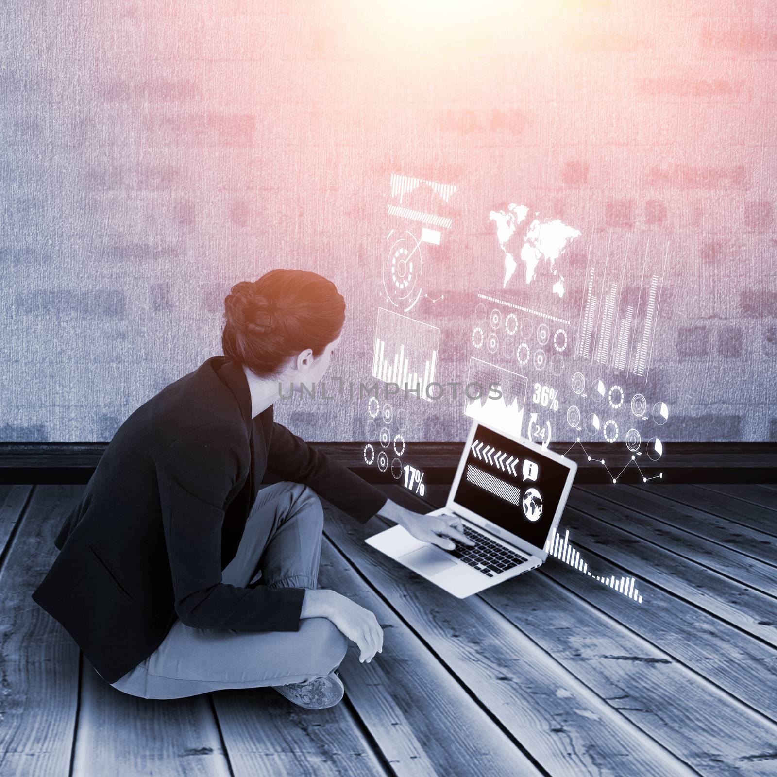 Businesswoman using laptop on white background against light on yellow brick wall