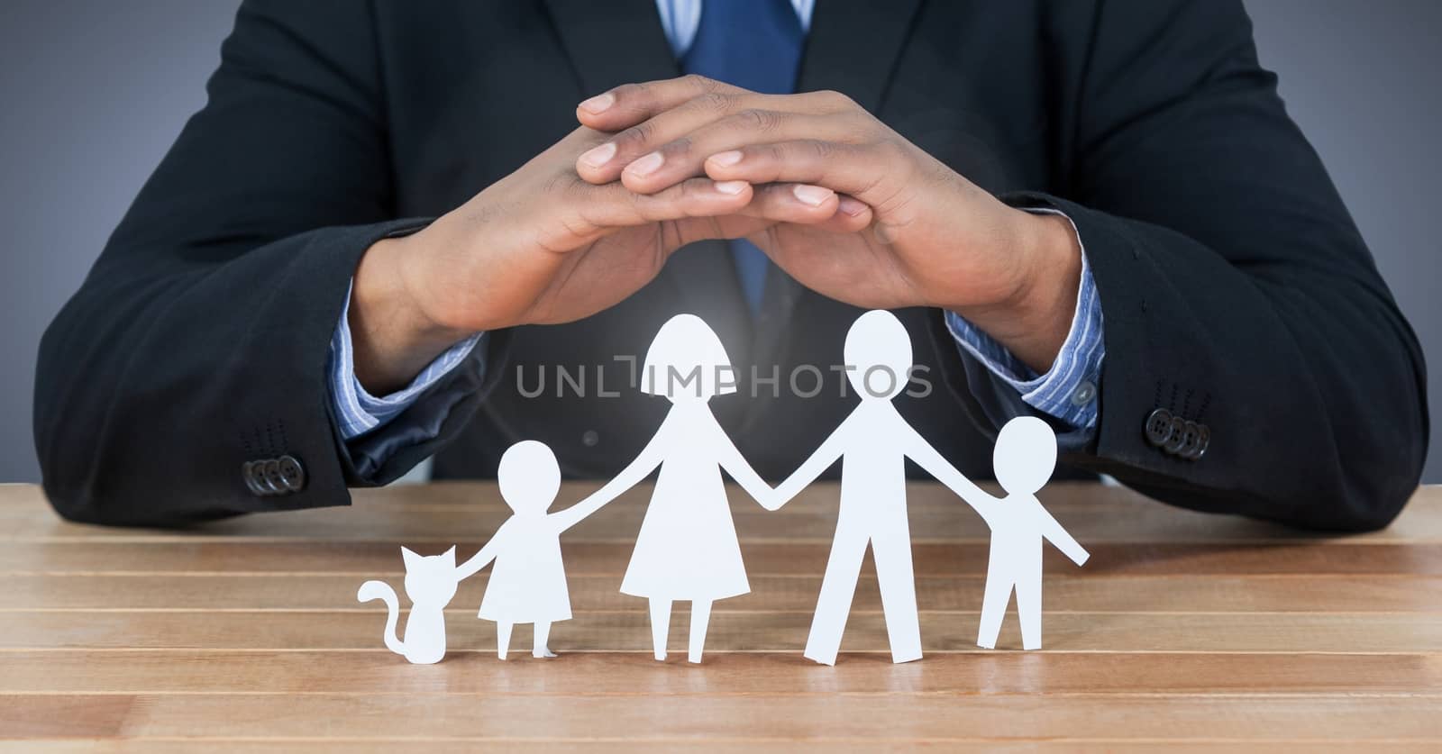 Digital composite of Cut out family under protective hands