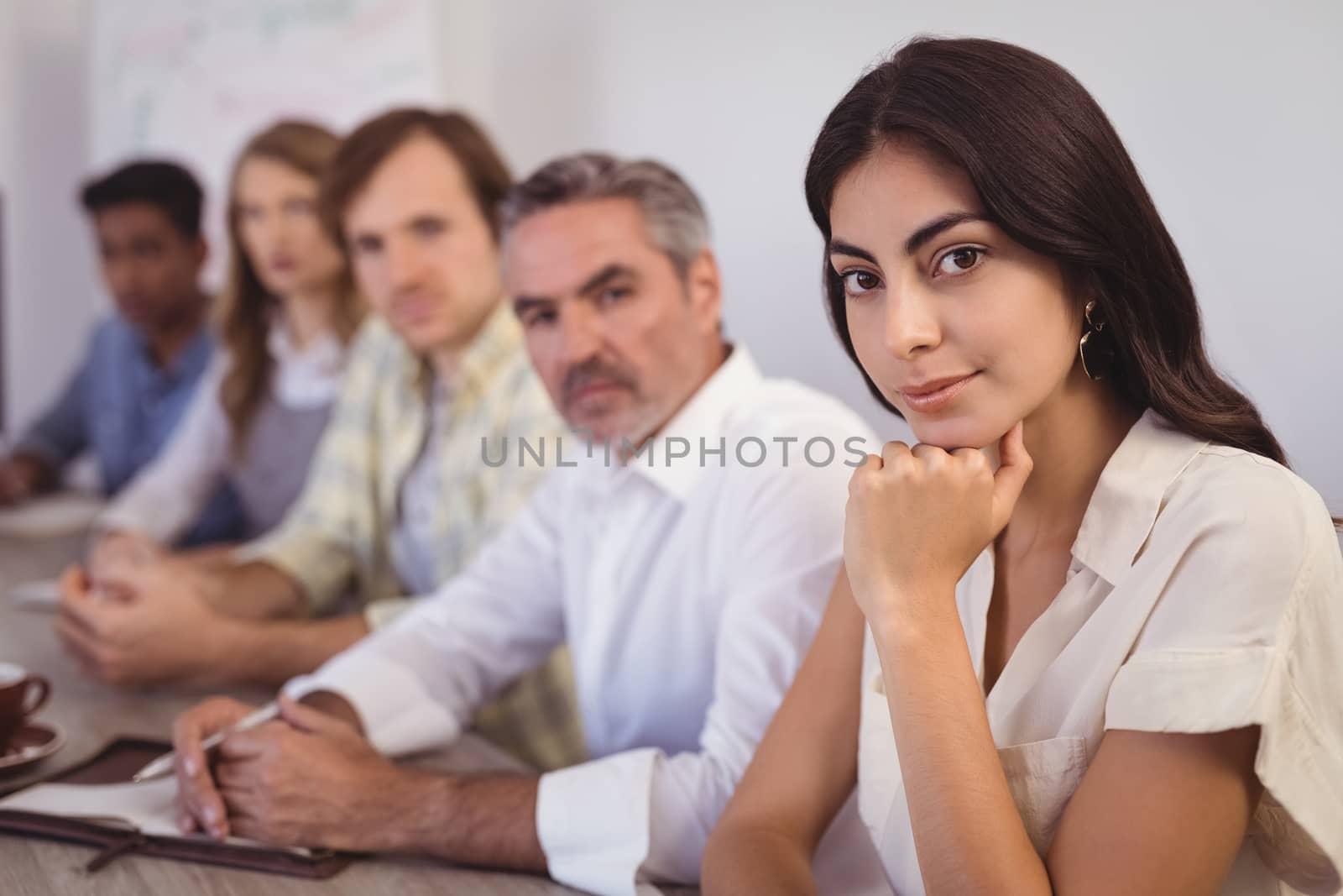 Portrait of business people sitting in conference room