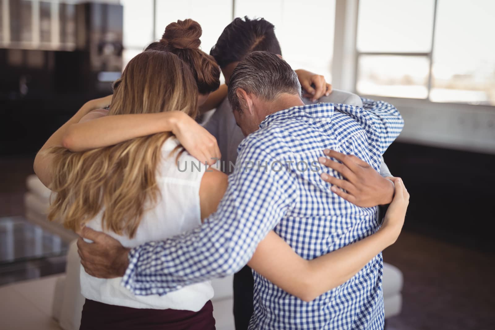 Business people huddling together at creative office