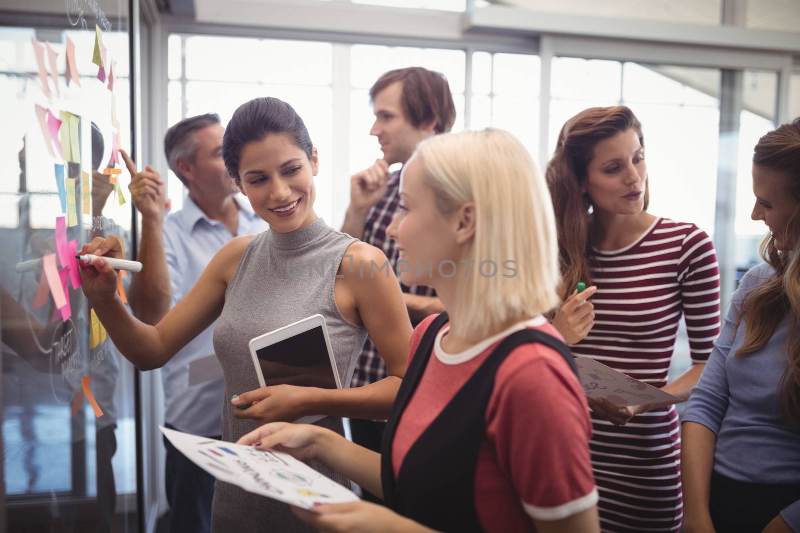 Business people discussing while planning in creative office