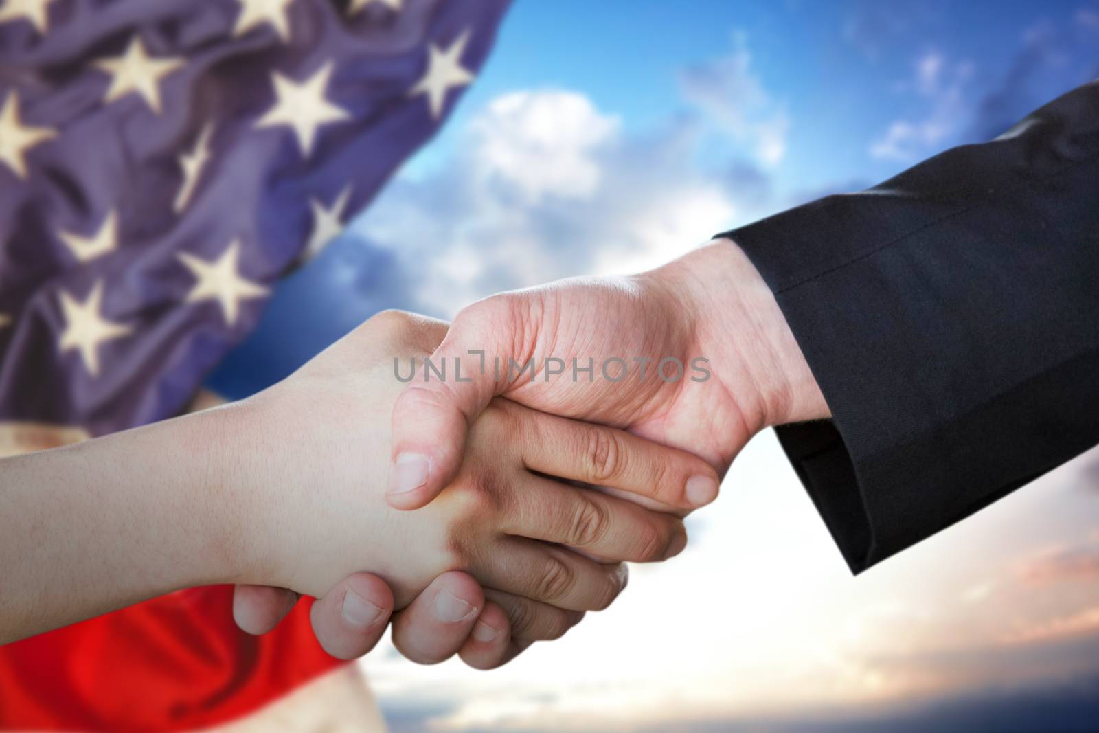 People doing handshake against cloudy sky