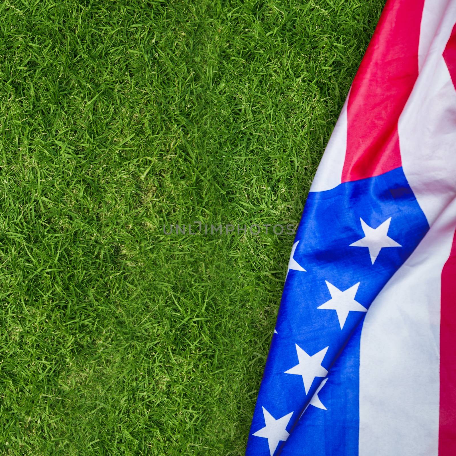 US flag against closed up view of grass