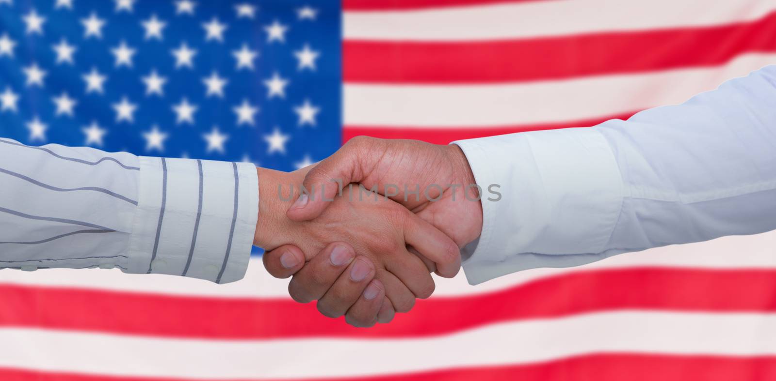 Business people shaking hands  against rippled us flag