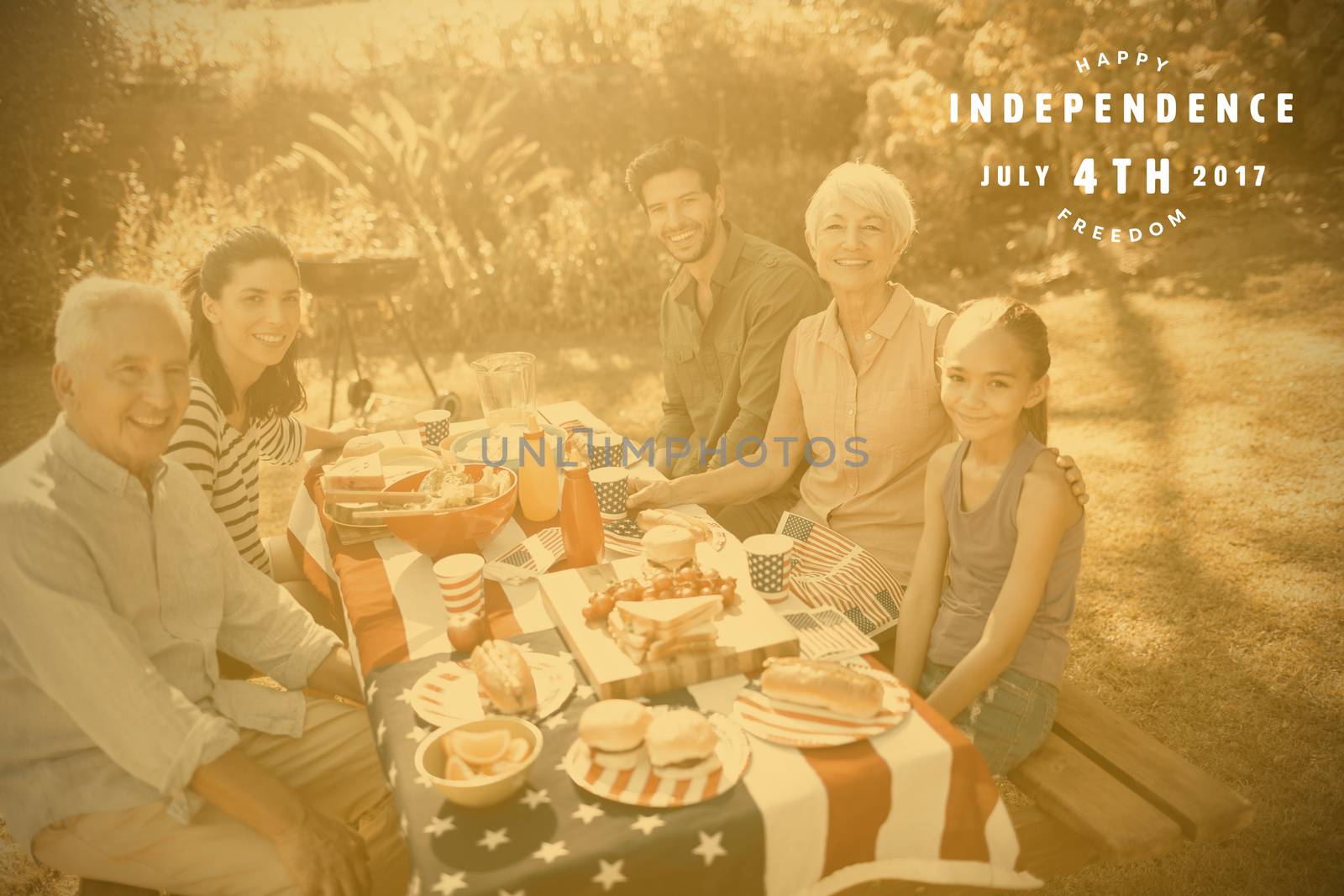 Computer graphic image of happy 4th of july text against happy family having a picnic