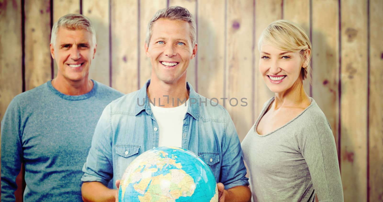 Portrait of people with globe  against wooden planks