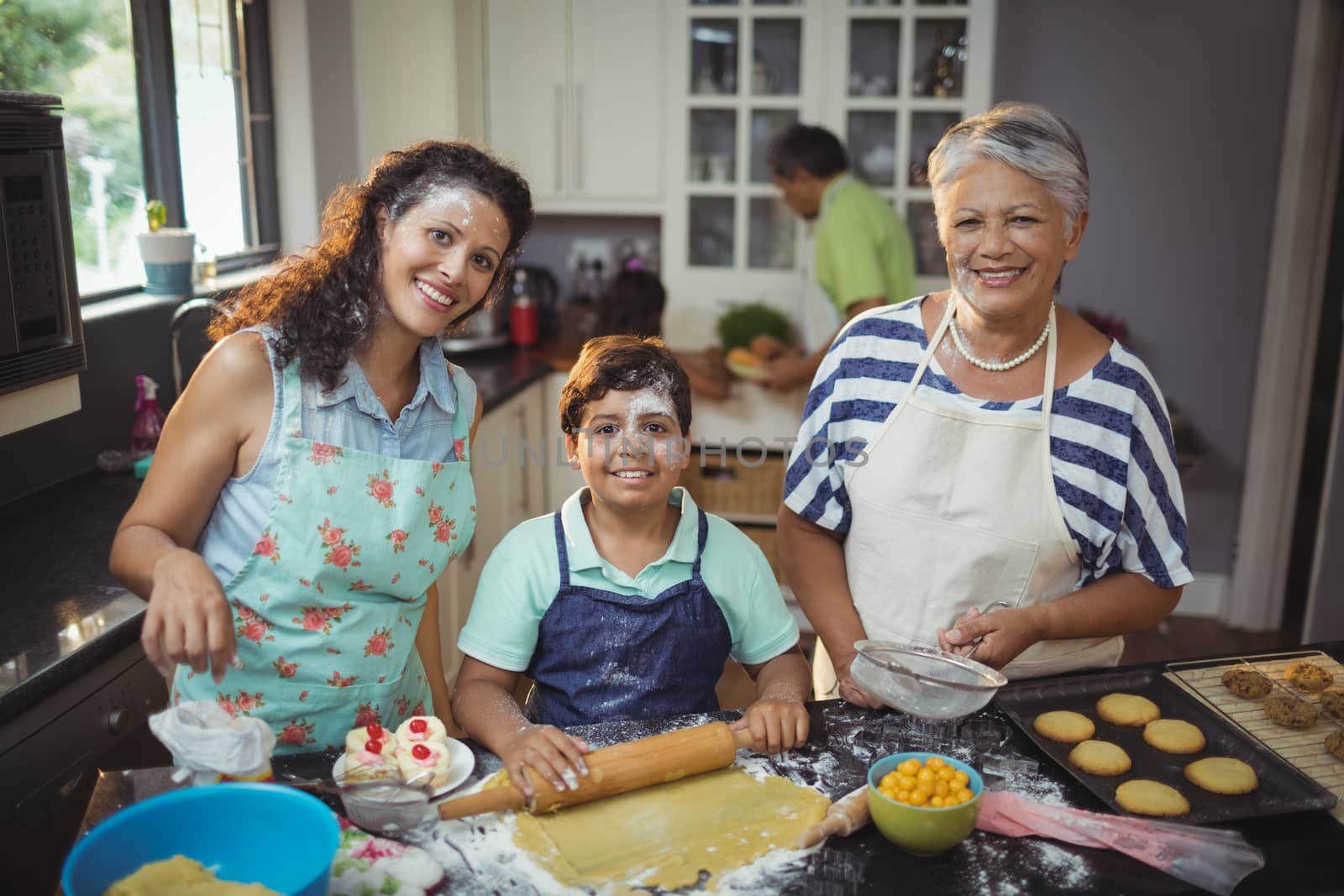 Family preparing dessert in kitchen at home