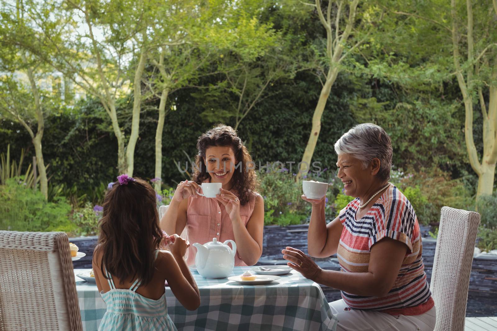 Happy family having tea at home