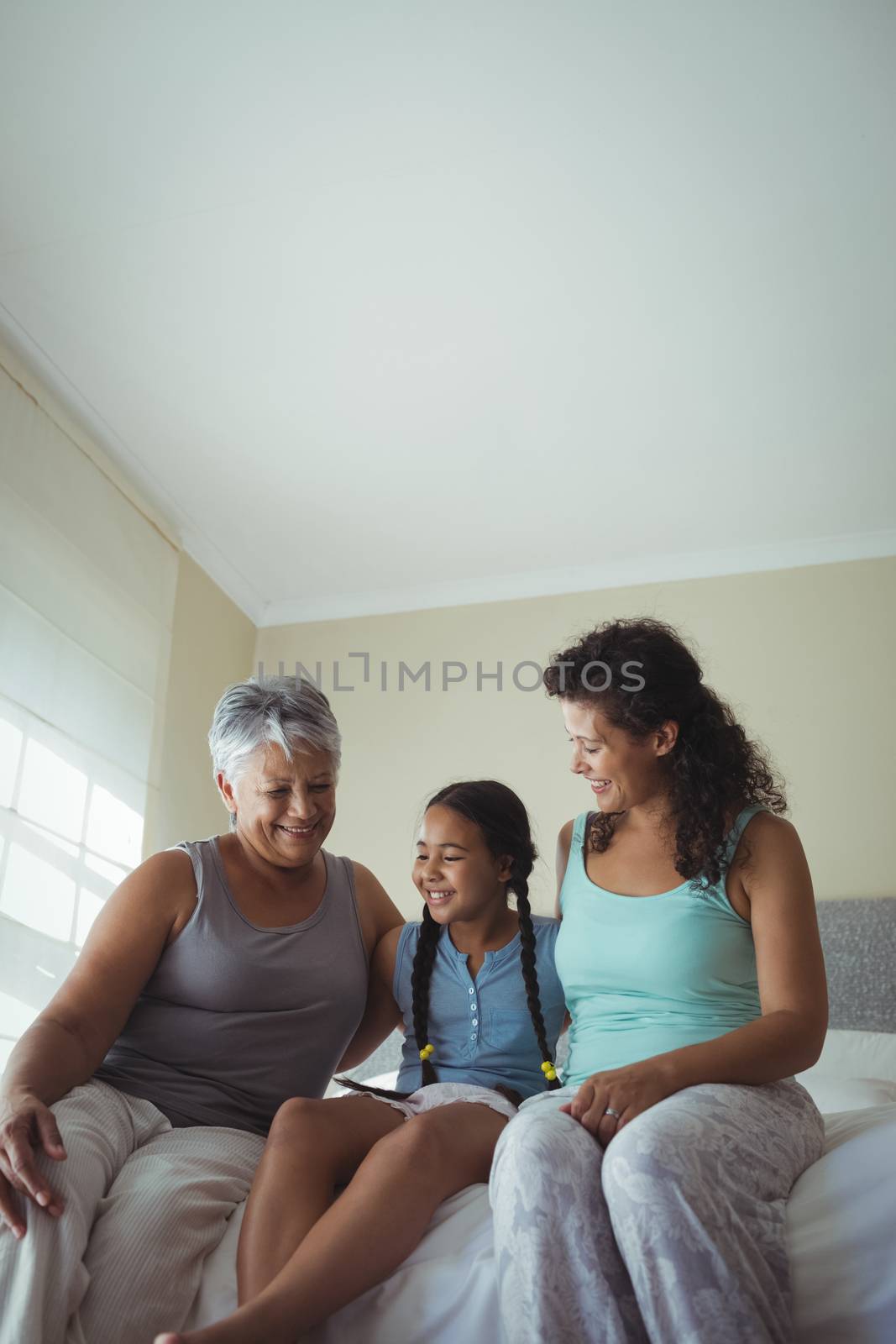 Happy family having fun on bed in bed room at home