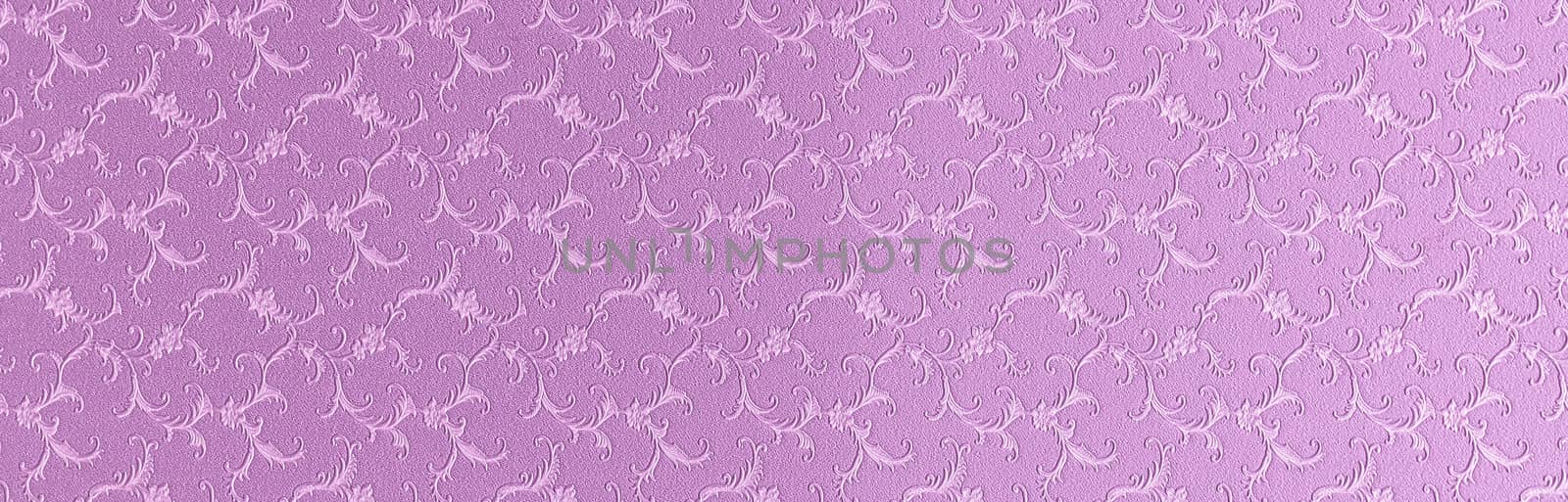 Embossed floral pattern on pink paper. Textured paper with copy space. Light pink, color of summer sunset, paper surface, closeup texture