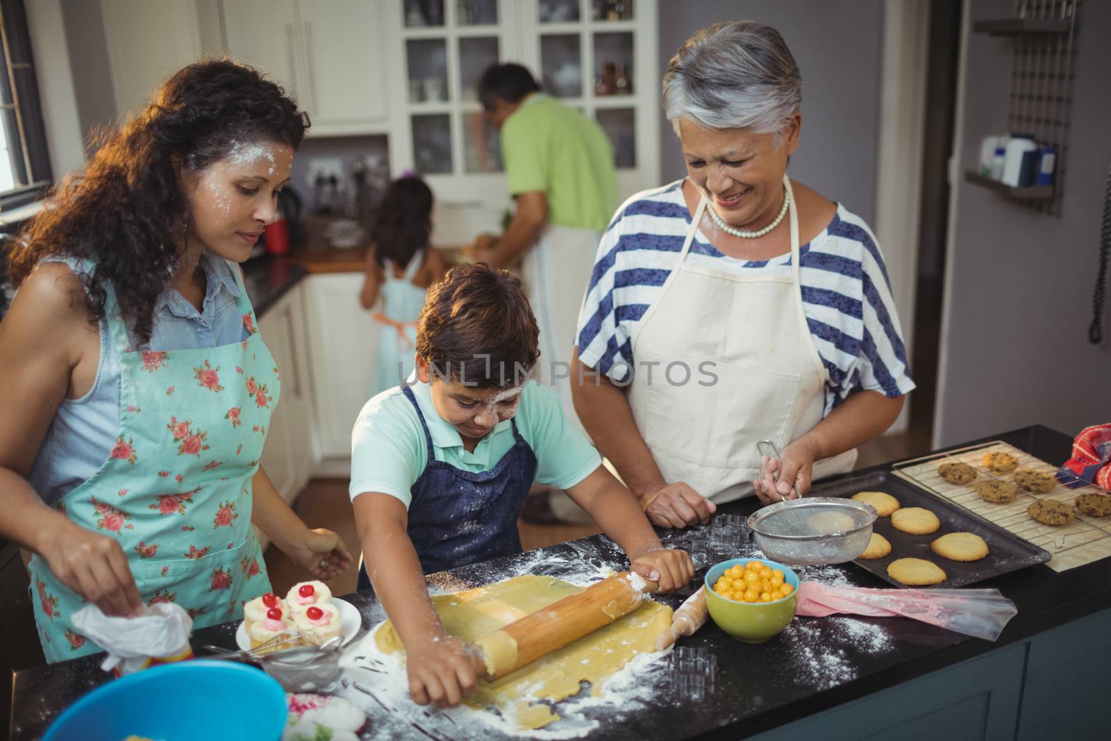 Family preparing dessert in kitchen by Wavebreakmedia