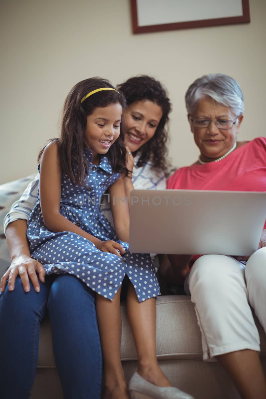 Happy family using laptop in living room at home