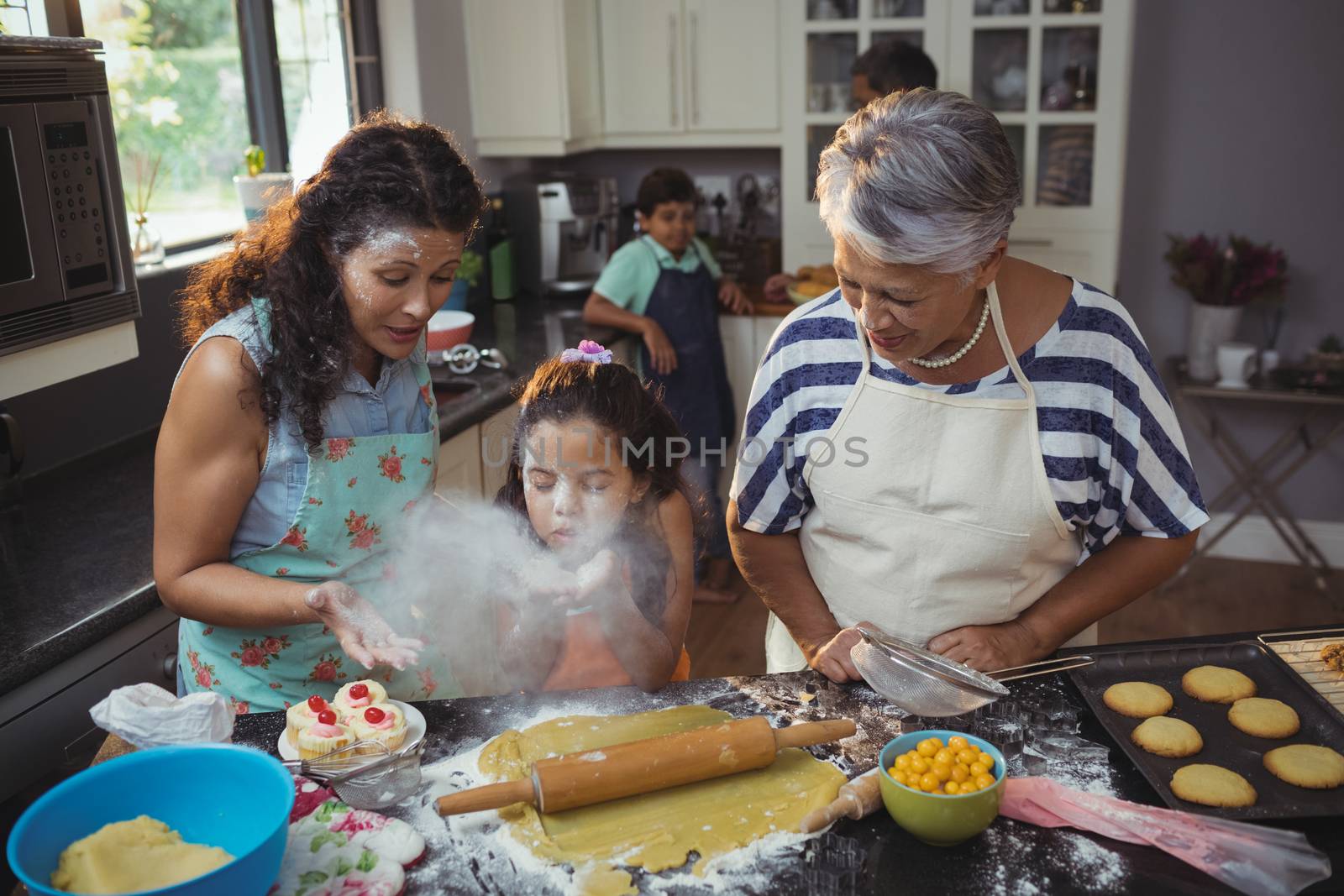 Family preparing dessert in kitchen at home