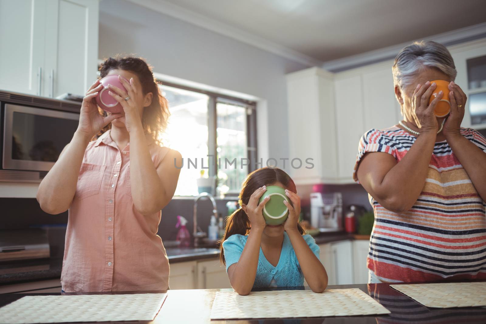 Family having soup in kitchen at home