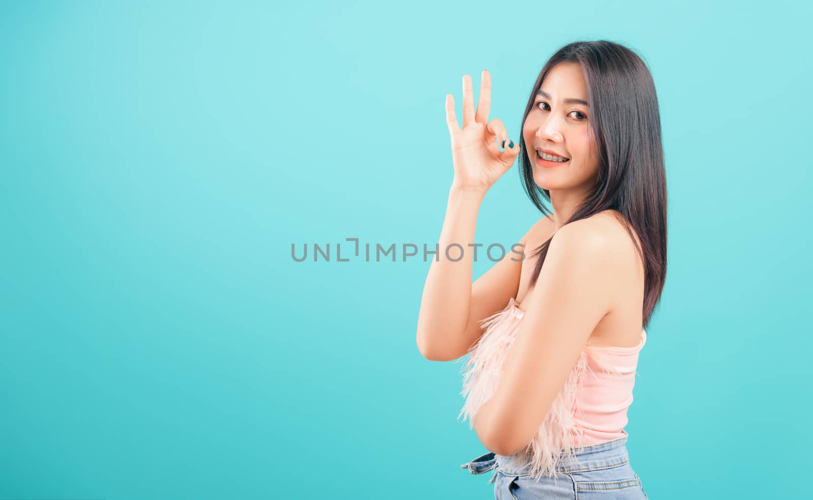 Portrait asian beautiful woman smiling showing finger OK sign an by Sorapop